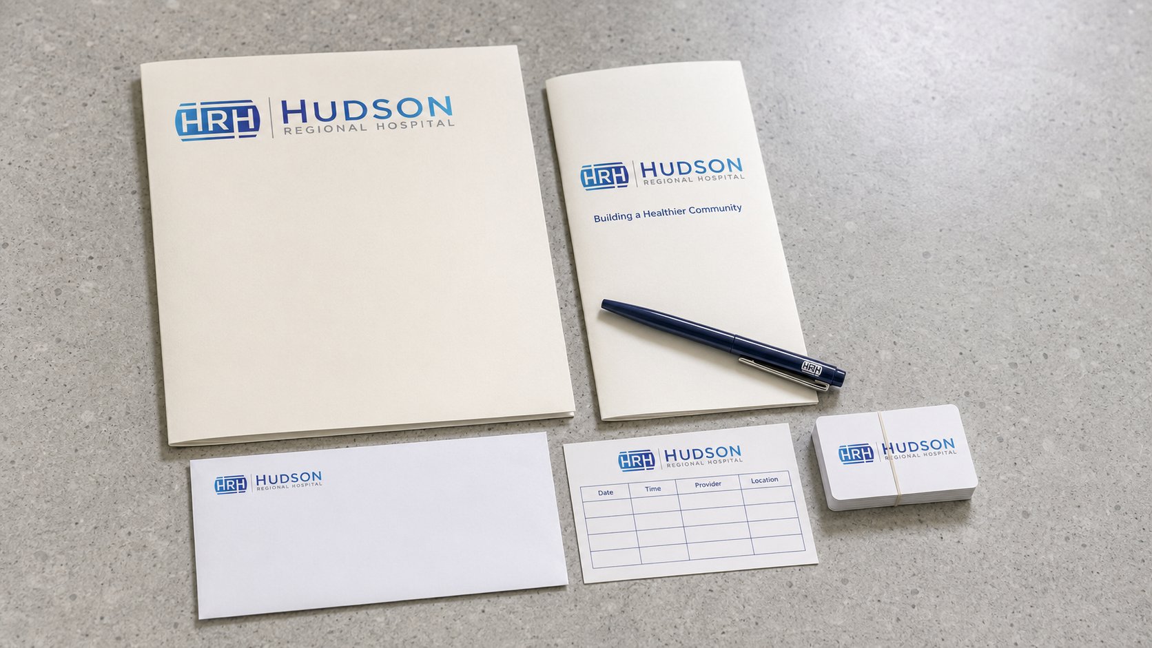 Brand visualization of the Hudson Regional Hospital patient welcome kit, folder, handbook, envelope, appointment card, and pen